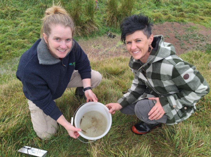 Senior biodiversity advisor Jenna Hughes-Games and landowner, Gemma Barker are pictured with Canterbury mudfish (Kōwaro) found in Papaka Stream.