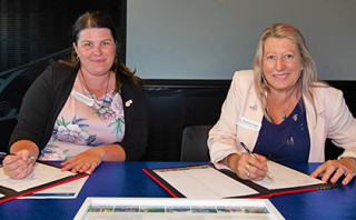 Environment Canterbury Councilor Nicole Marshall signing with Christchurch City Councillor Pauline Cotter