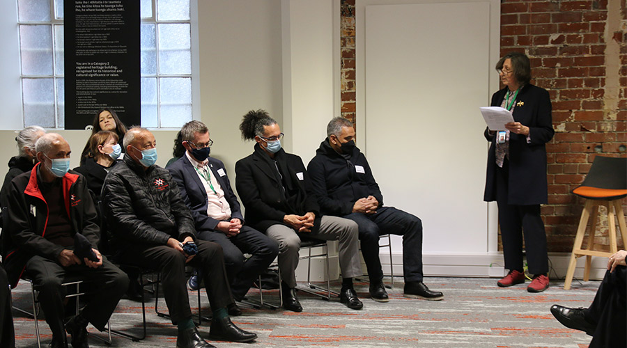 Chair Jenny Hughley speaks at the opening with representatives from Te Taumata o Ngāi Tūāhuriri to her left. The Te Taumata o Ngāi Tūāhuriri team blessed the building and unveiled a tukutuku panel and whakairo carving.
