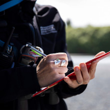 Report it now staff holding pen and paper