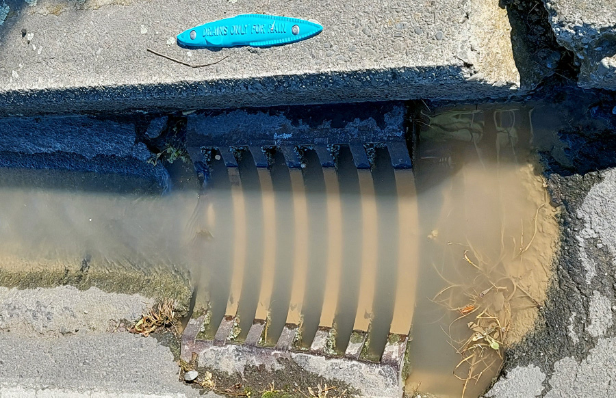 Sediment (dirt) in a Stormwater drain leading to a river.